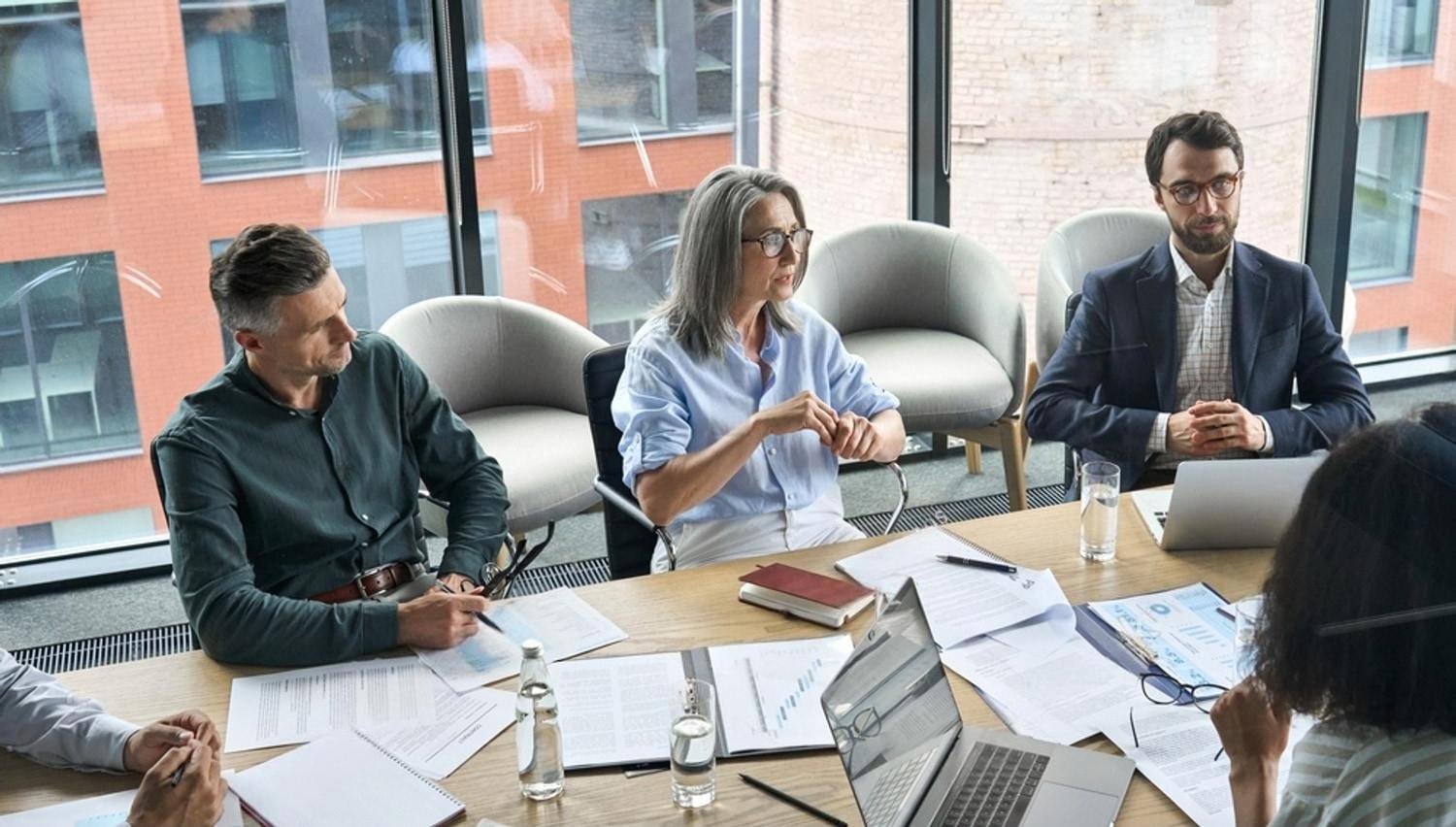 Executives discussing strategy in a modern UAE boardroom during a leadership session